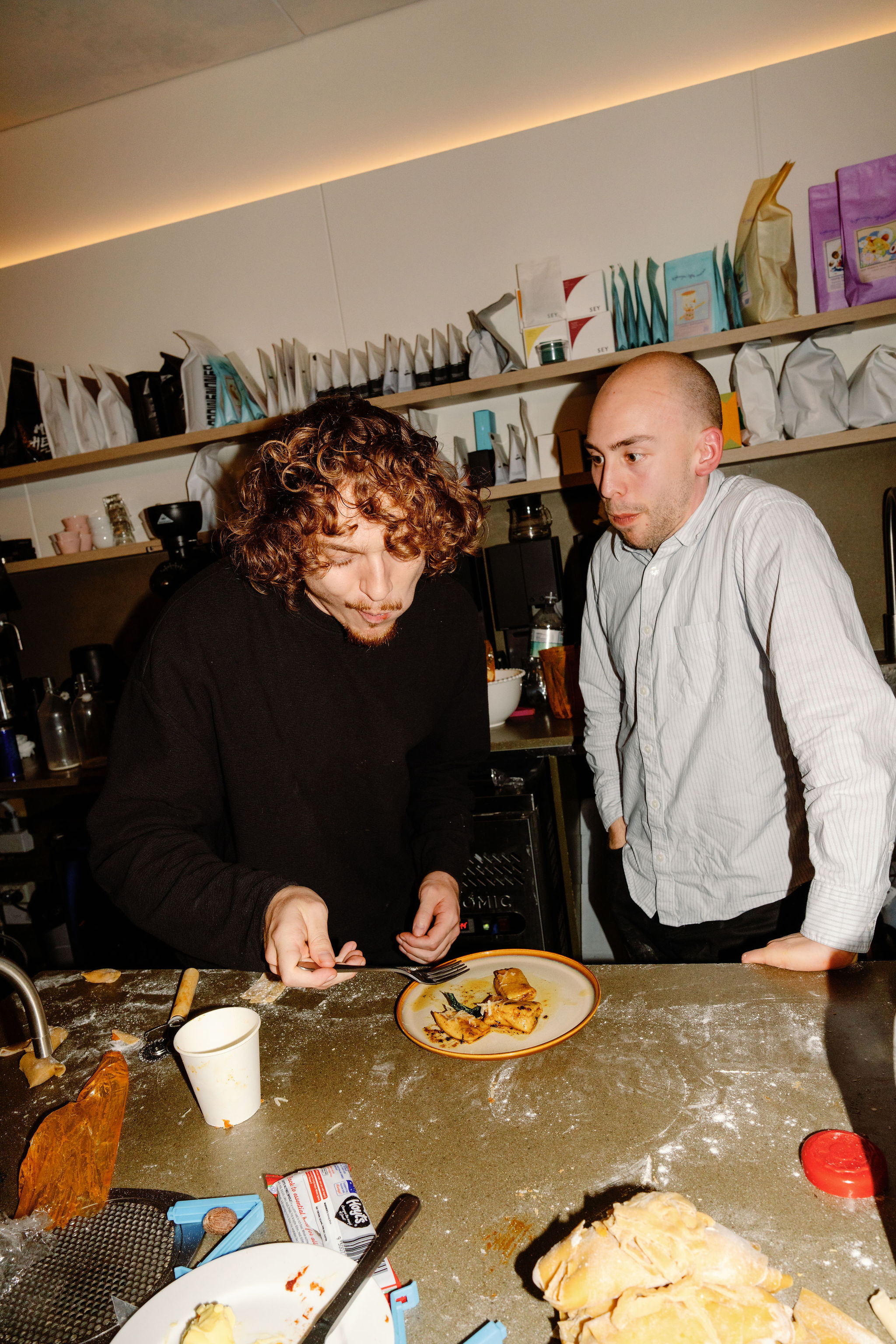 Tasting pasta together in the kitchen
