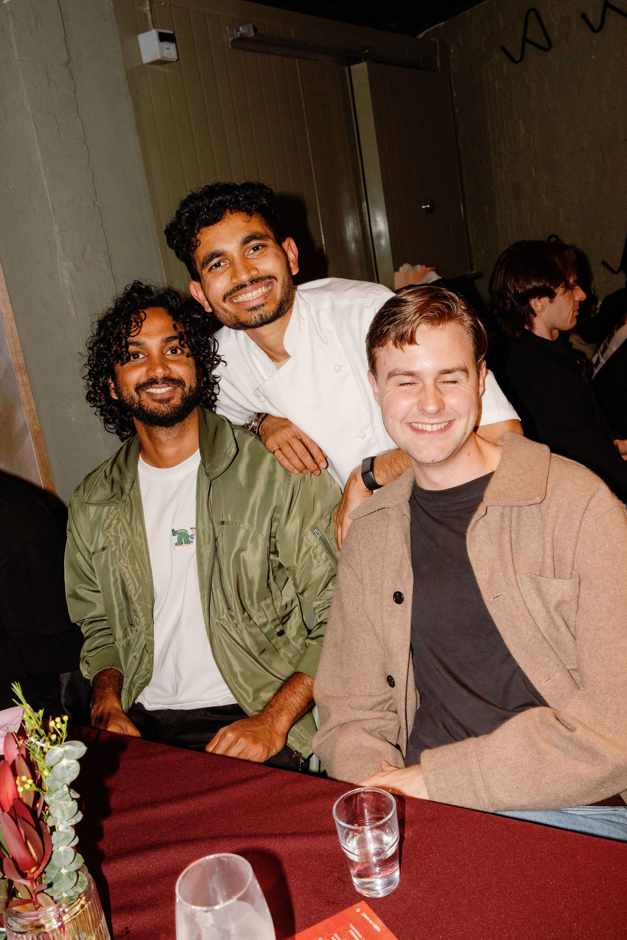 Friends smiling together at the dinner table